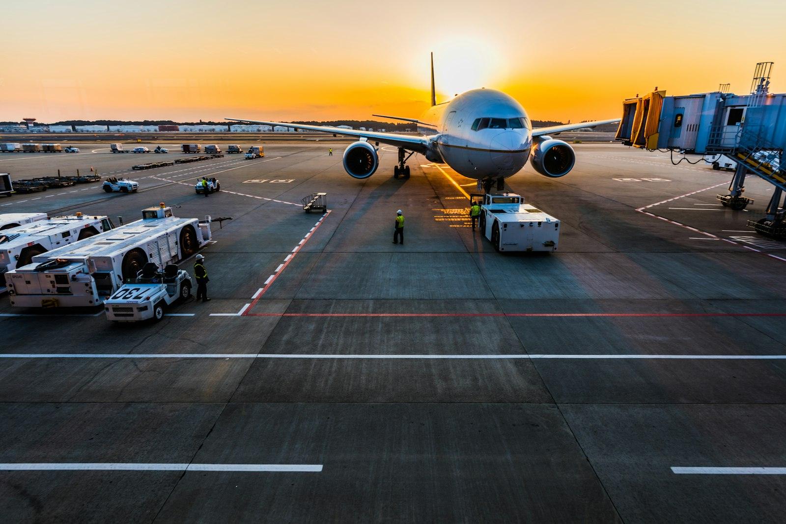 Wide-body aircraft on the apron at sunset